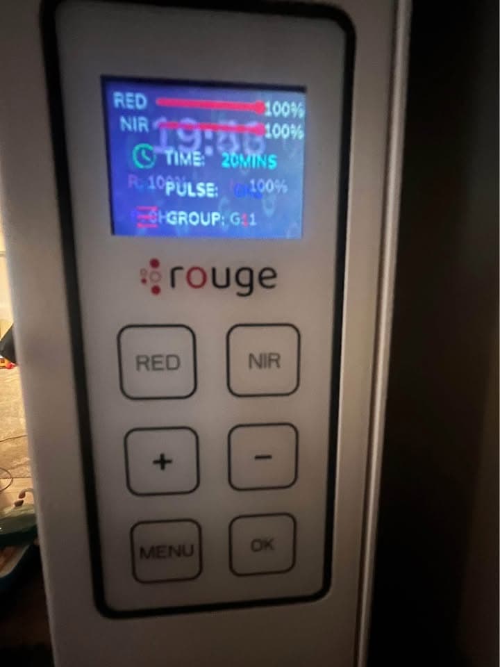 Clinical testing and setup of the Rouge Ultimate G4 red light therapy panel demonstrating its interactive touchscreen and app controls.