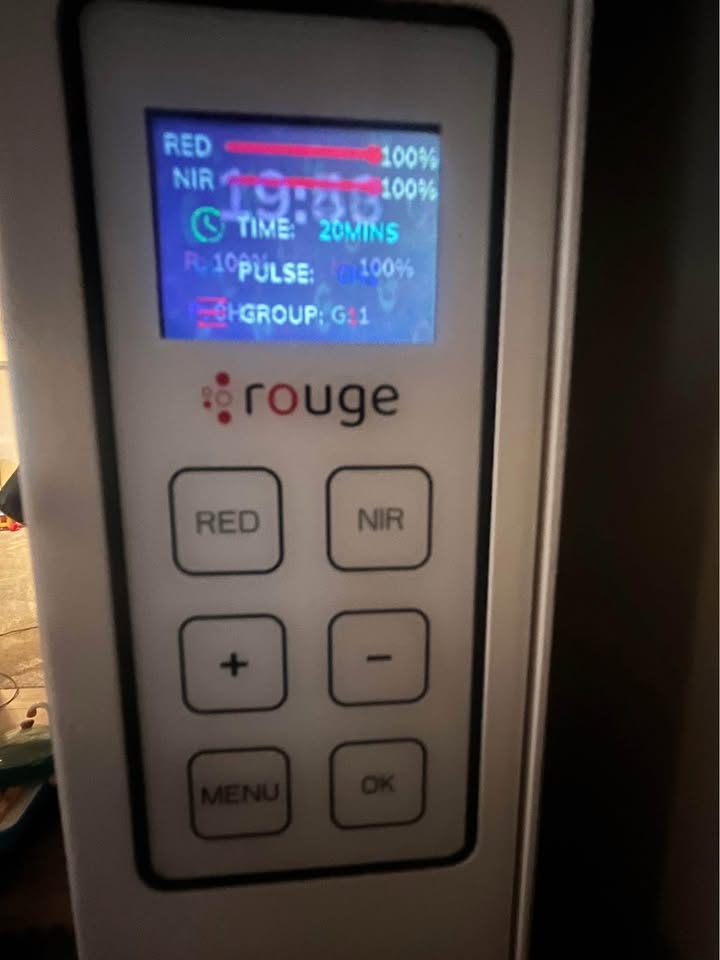 Clinical testing and setup of the Rouge Ultimate G4 red light therapy panel demonstrating its interactive touchscreen and app controls.